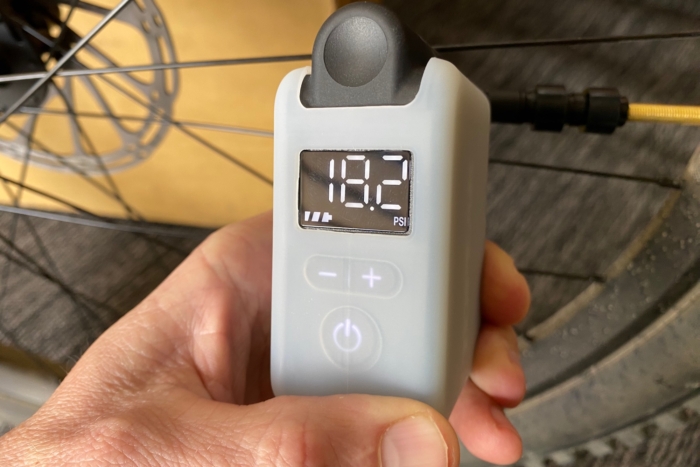 Inflating a mountain bike tire with the Topeak E-Booster Digital electric bike pump