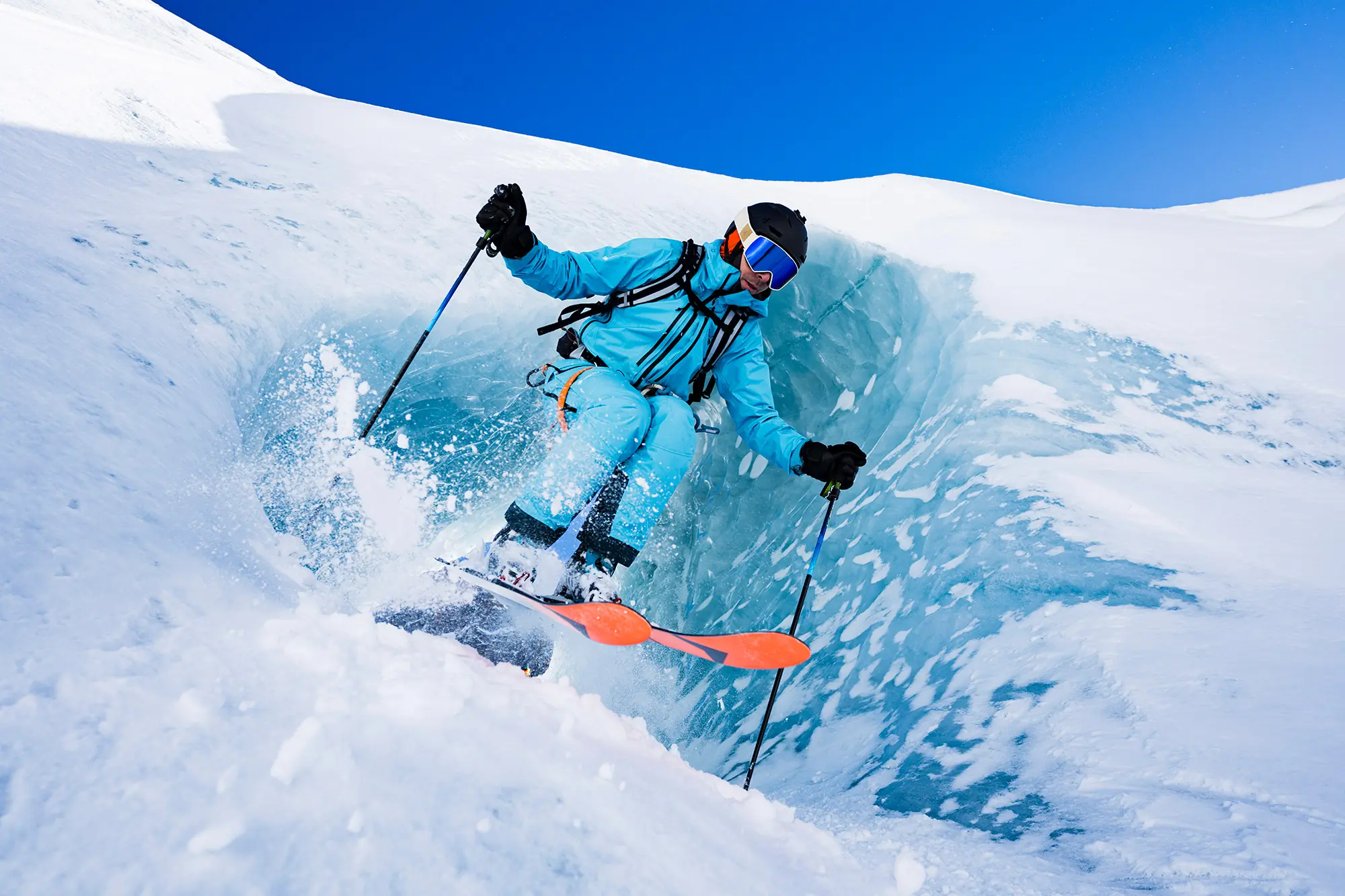 Vivian skis down a blue-walled ice chute