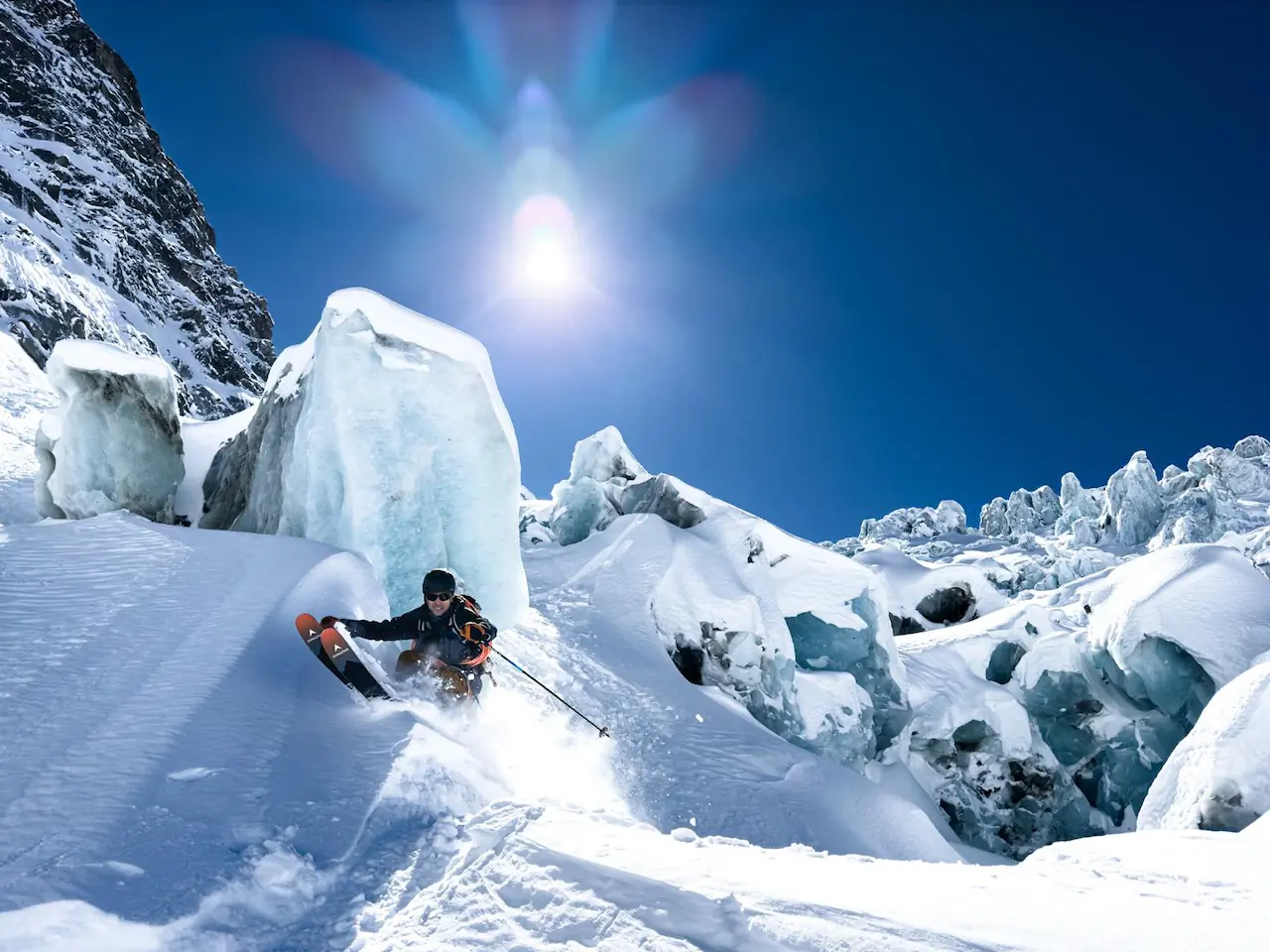 Vivian descends past massive glacial ice under clear skies