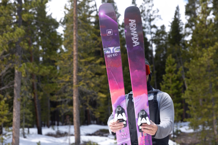 Skier holding Armada ARV 100 skis outside in snow