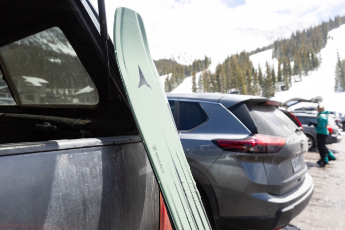 Atomic Maverick 96 skis leaning against a car