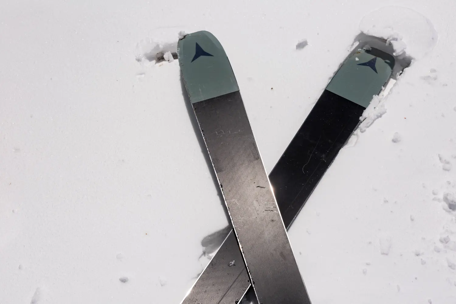 A pair of Atomic Maverick 96 CTi skis crossed in soft spring snow,