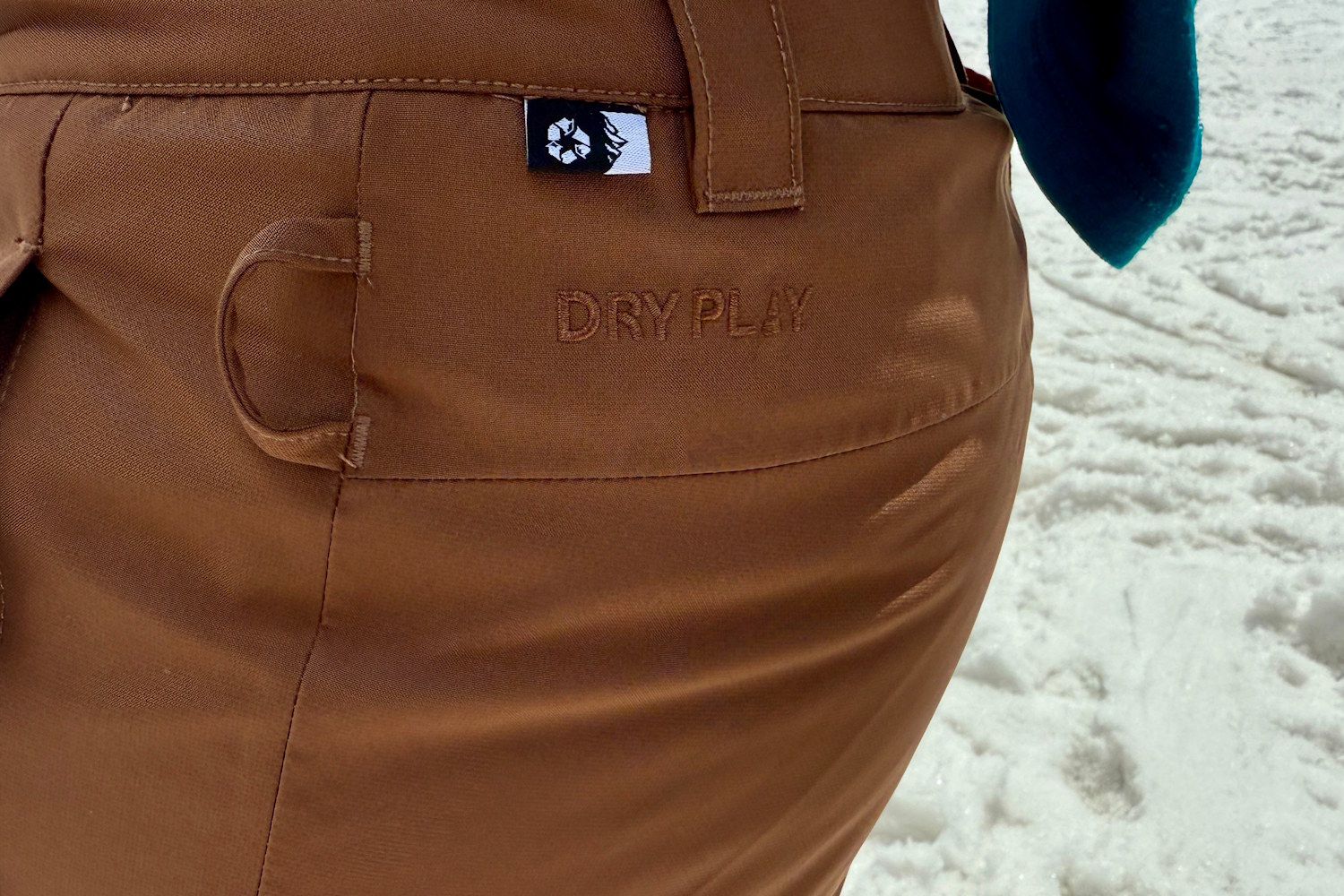 Closeup of Brown Exa snow pants with DRY PLY written on it