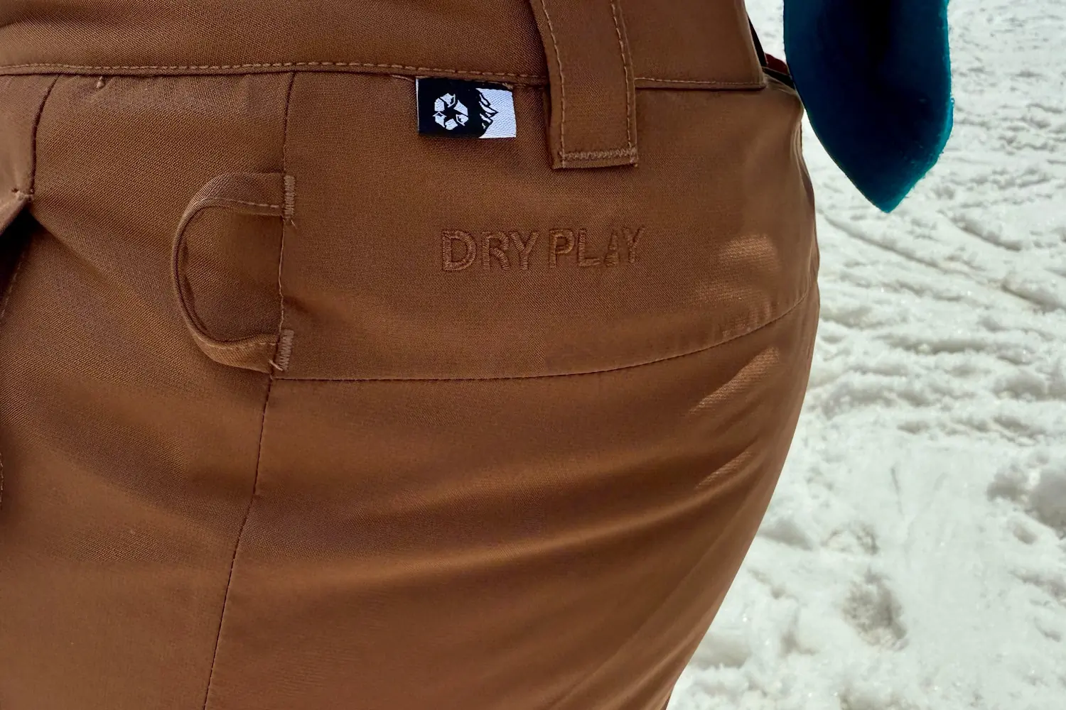 Closeup of Brown Exa snow pants with DRY PLY written on it