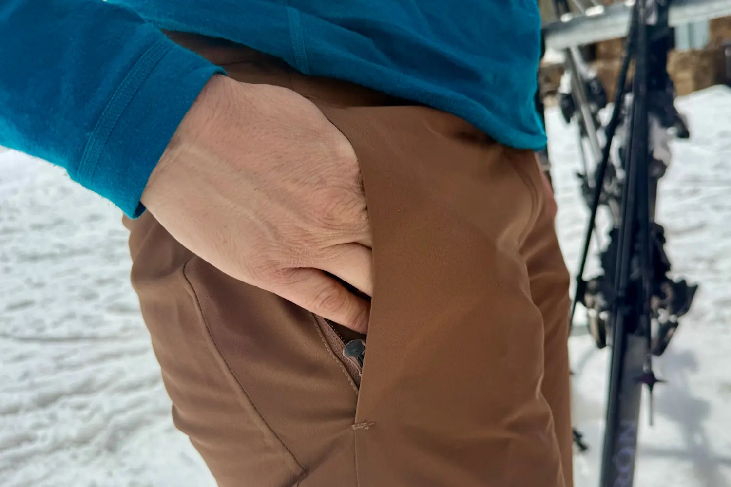Person Placing hand inside Exa snow pants
