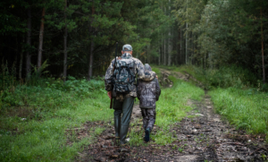 father sun hunting camo walking in woods
