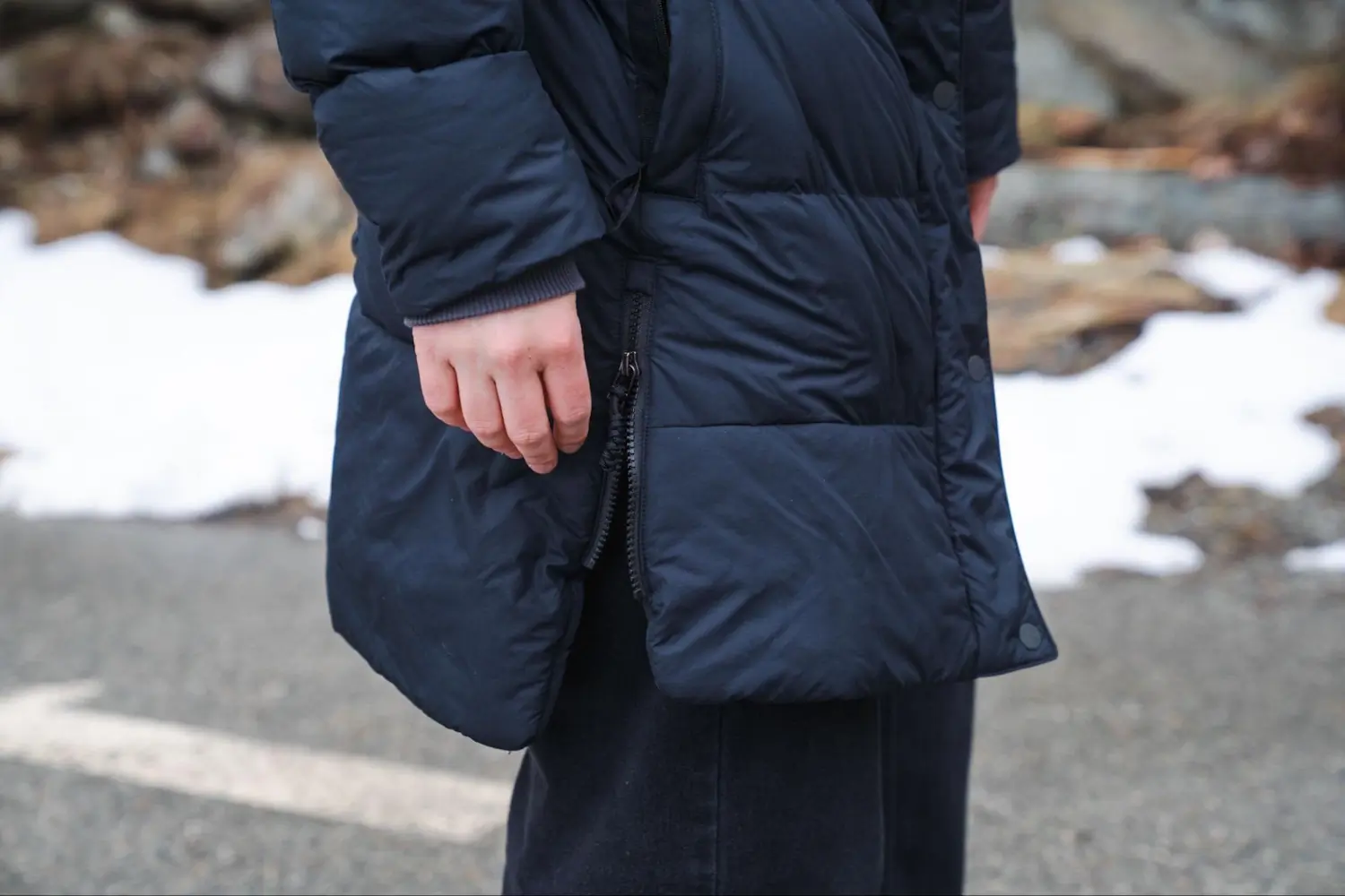 Side view of the REI Norseland Parka showing side zippers.