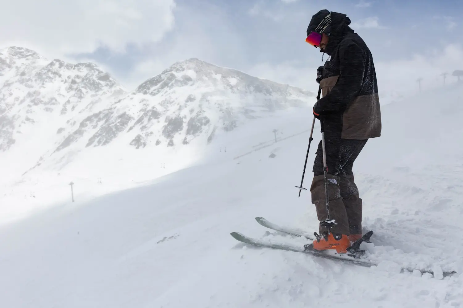 Skier testing Atomic Maverick 96 CTi skis on snow-covered terrain.