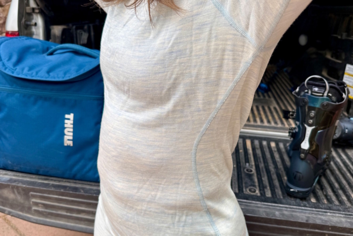 Close-up of Smartwool base layer crew top showing seam detail and snug, contoured fit.