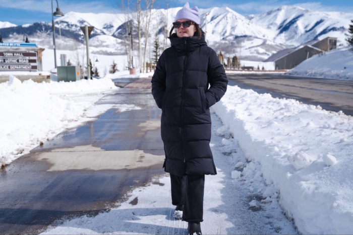 Women outside in snow testing OR coze down parka