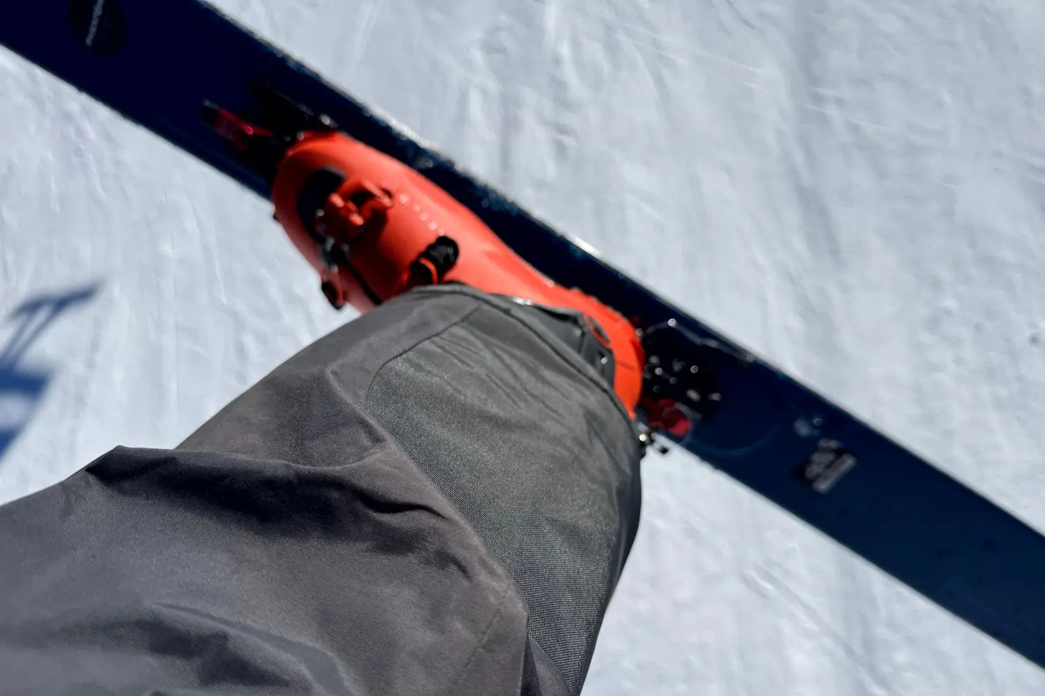 The reinforced instep patch of the Freedom Pants shown over a ski boot.