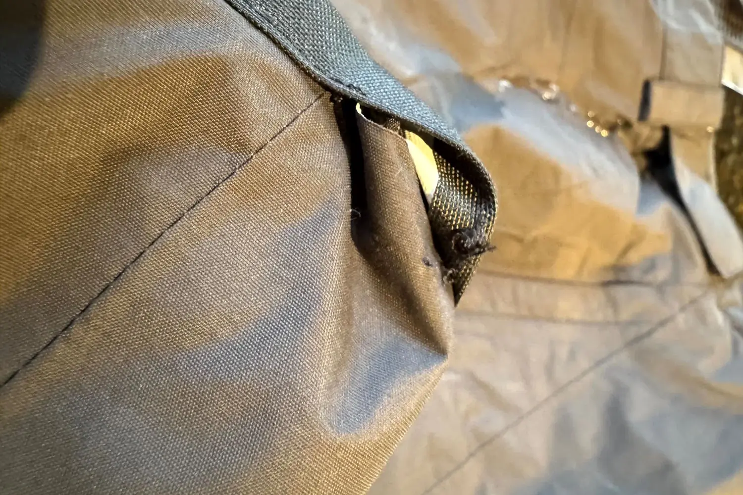 A close-up of a fraying seam near the cuff on The North Face Freedom Pants.