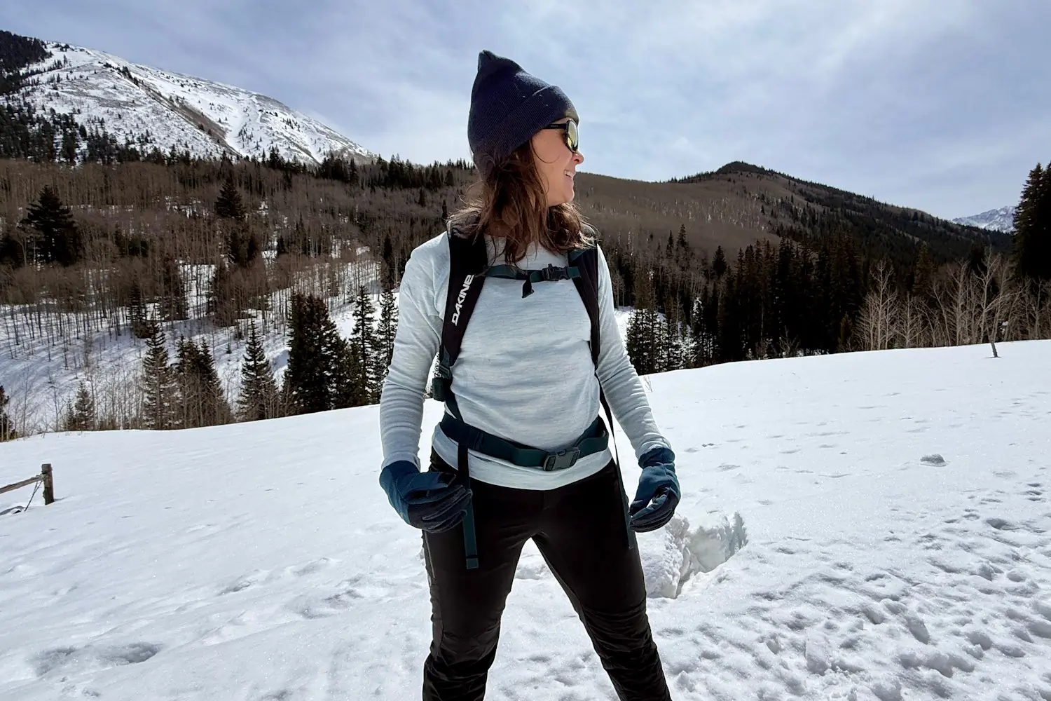 Woman in snow wearing Smartwool thermal base layer