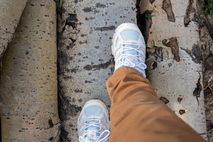 A person wearing Merrell Moab 3 shoes on wooden surface
