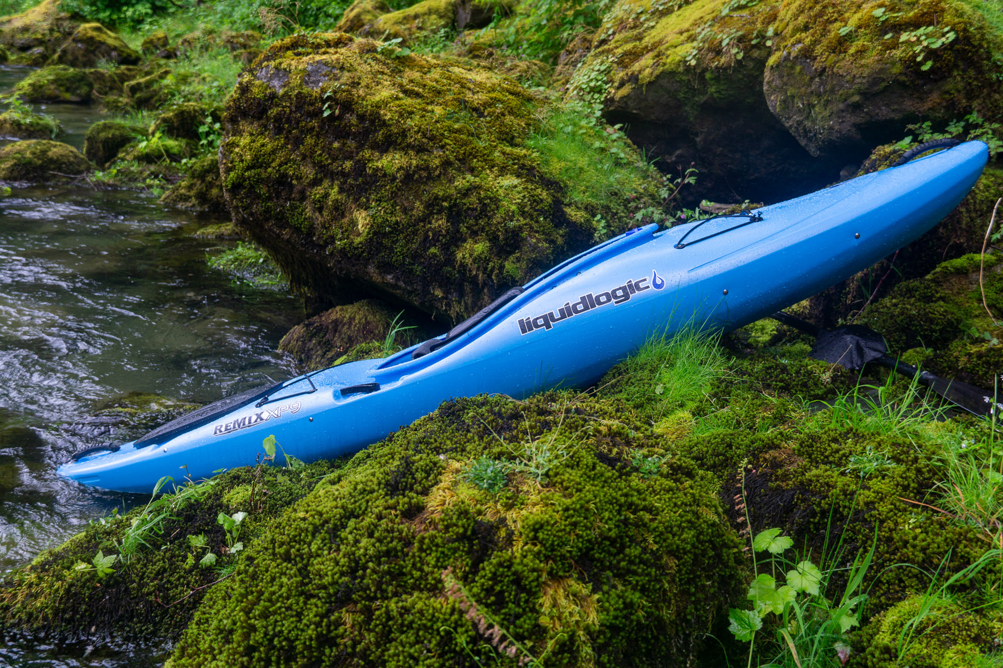 the liquidlogic remix xp pulled up on shore along the skagit river, surrounded by mossy rock