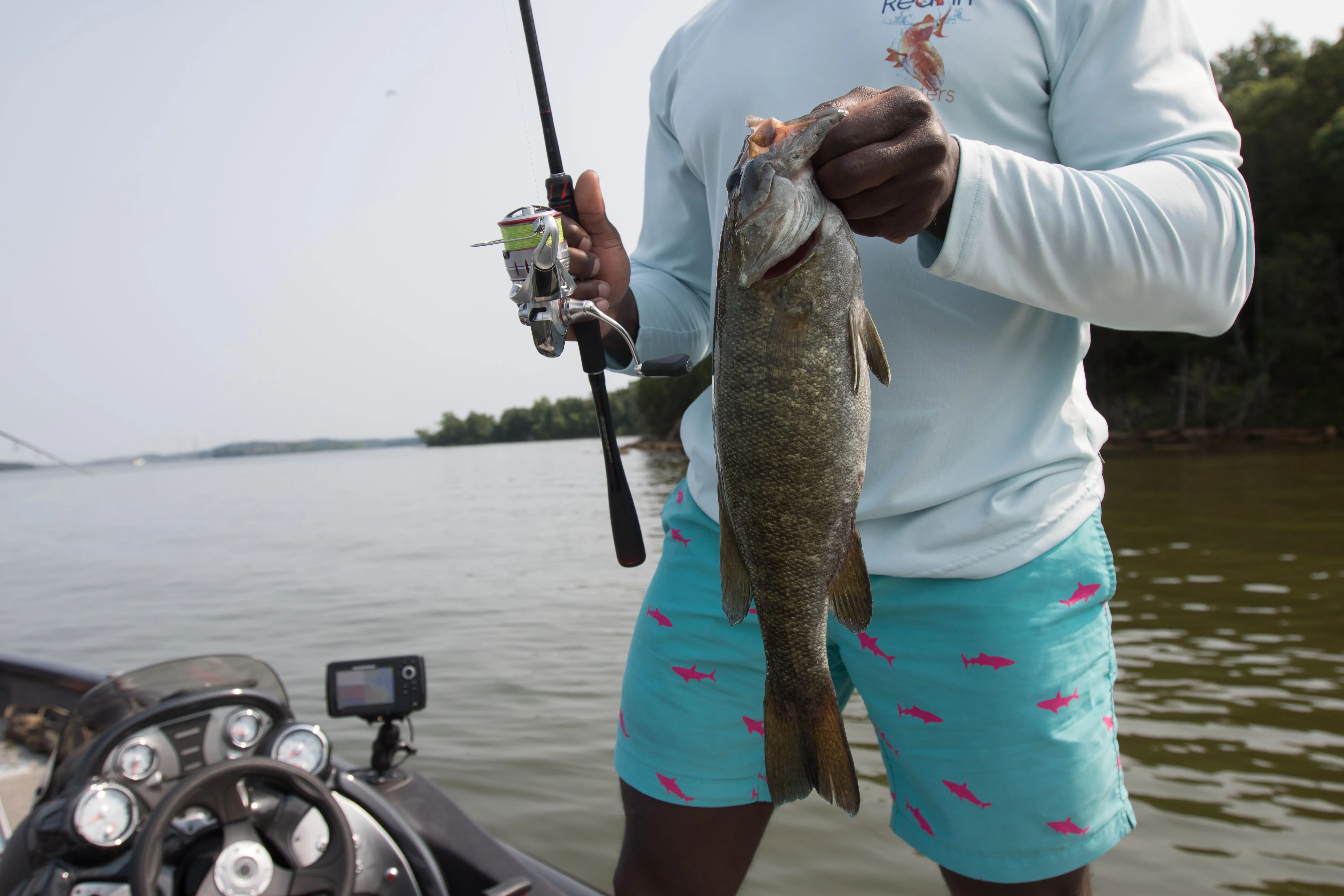 An angler holding a smallmouth bass