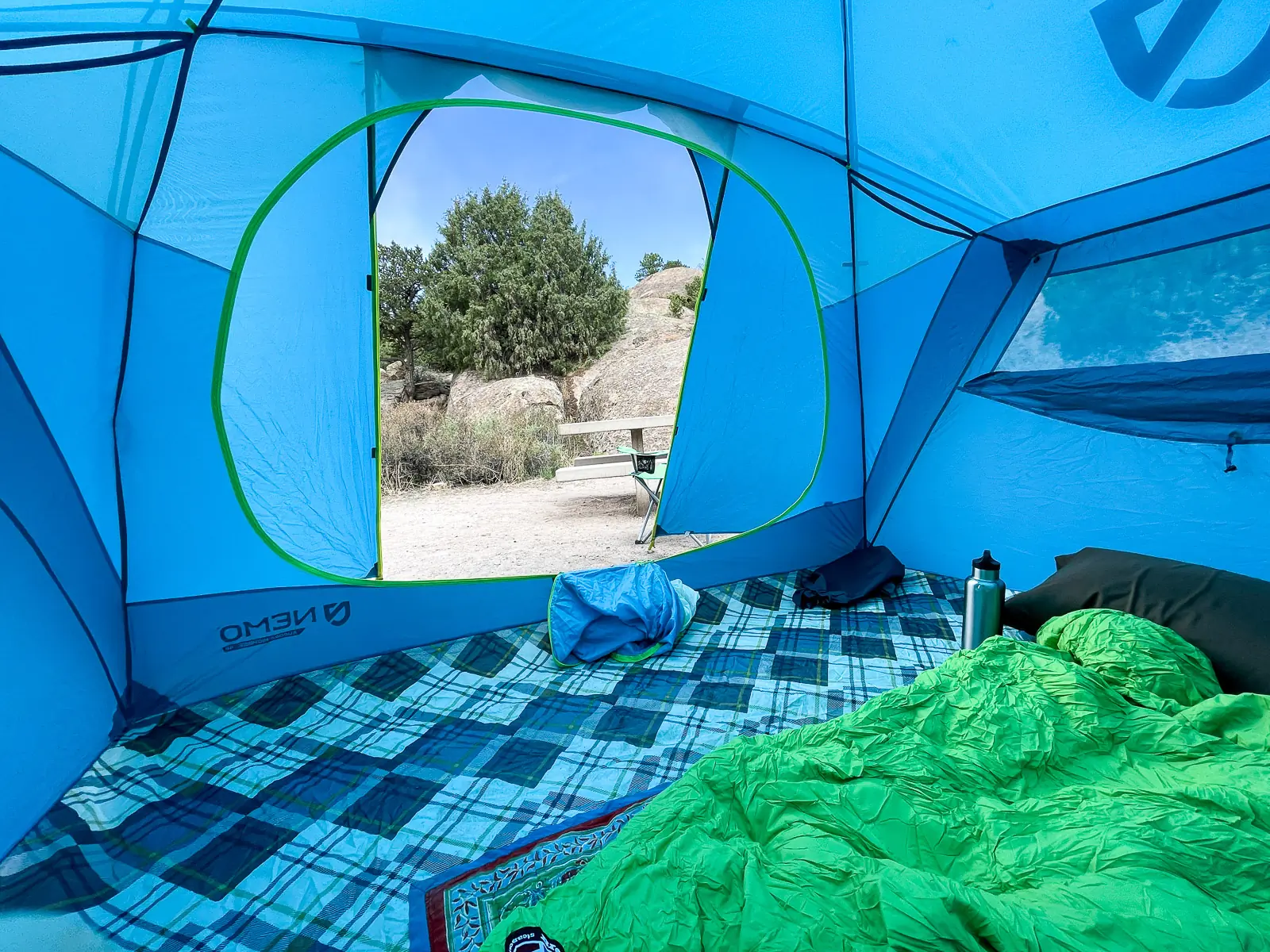 the interior of the tent looking out through the main door, with sleeping bags on the floor