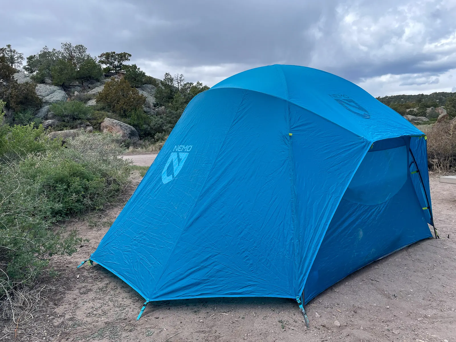 the aurora highrise tent seen from outside, showing the rain fly and how it extends out over the windows, not fully covering them