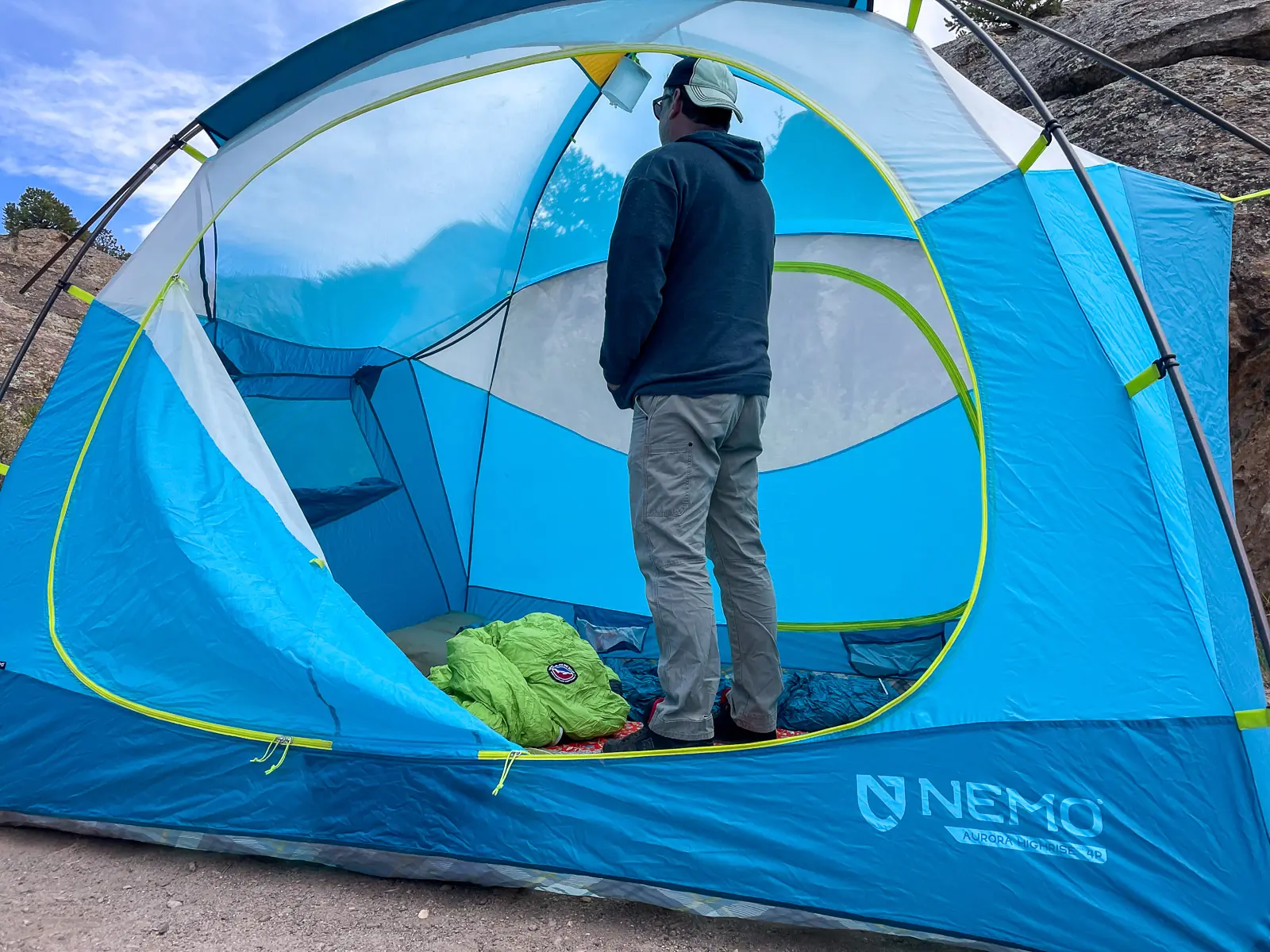 a tall camper stands up fully inside the nemo aurora highrise tent