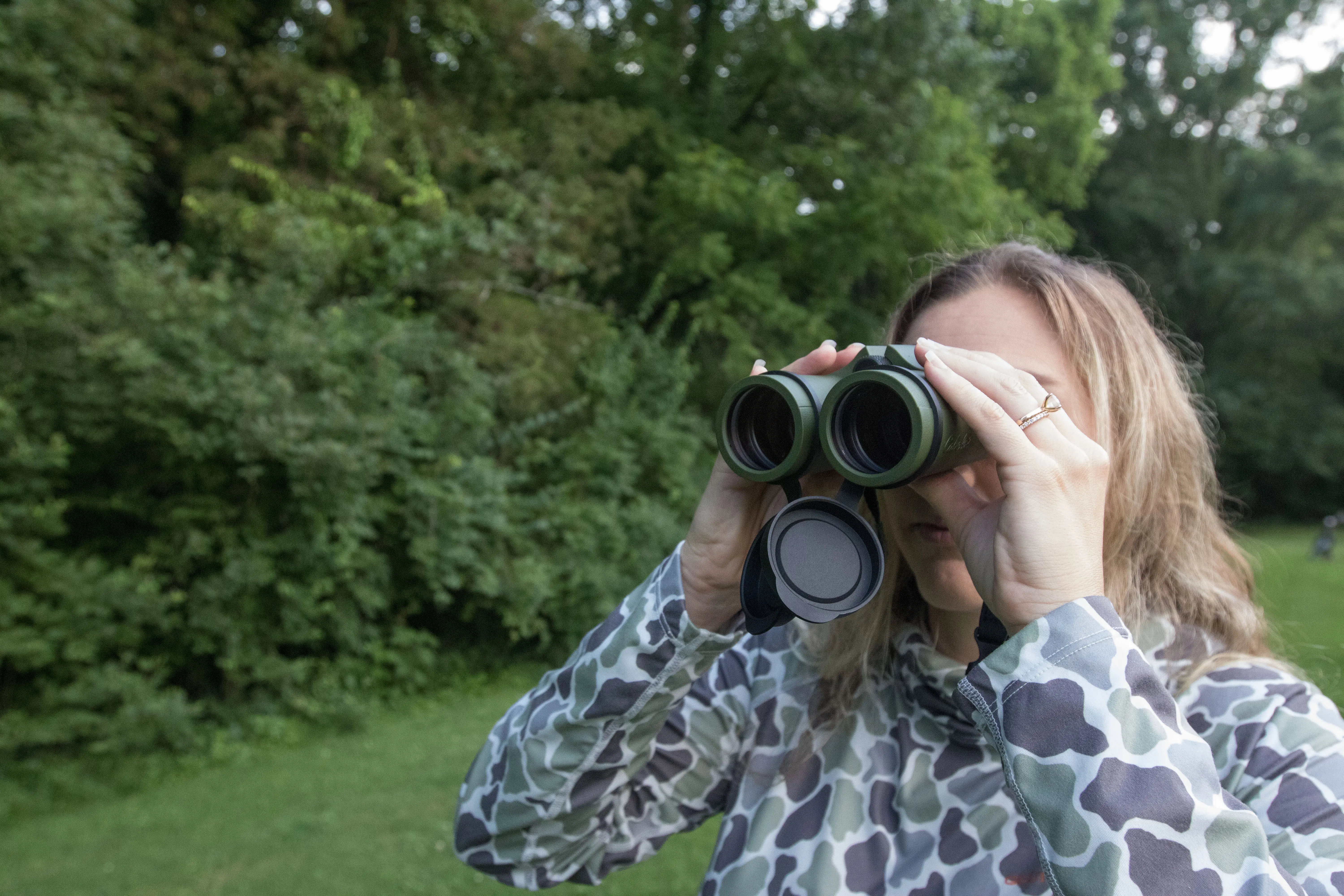 A woman looking through the Cabela's Intensity ED Binoculars
