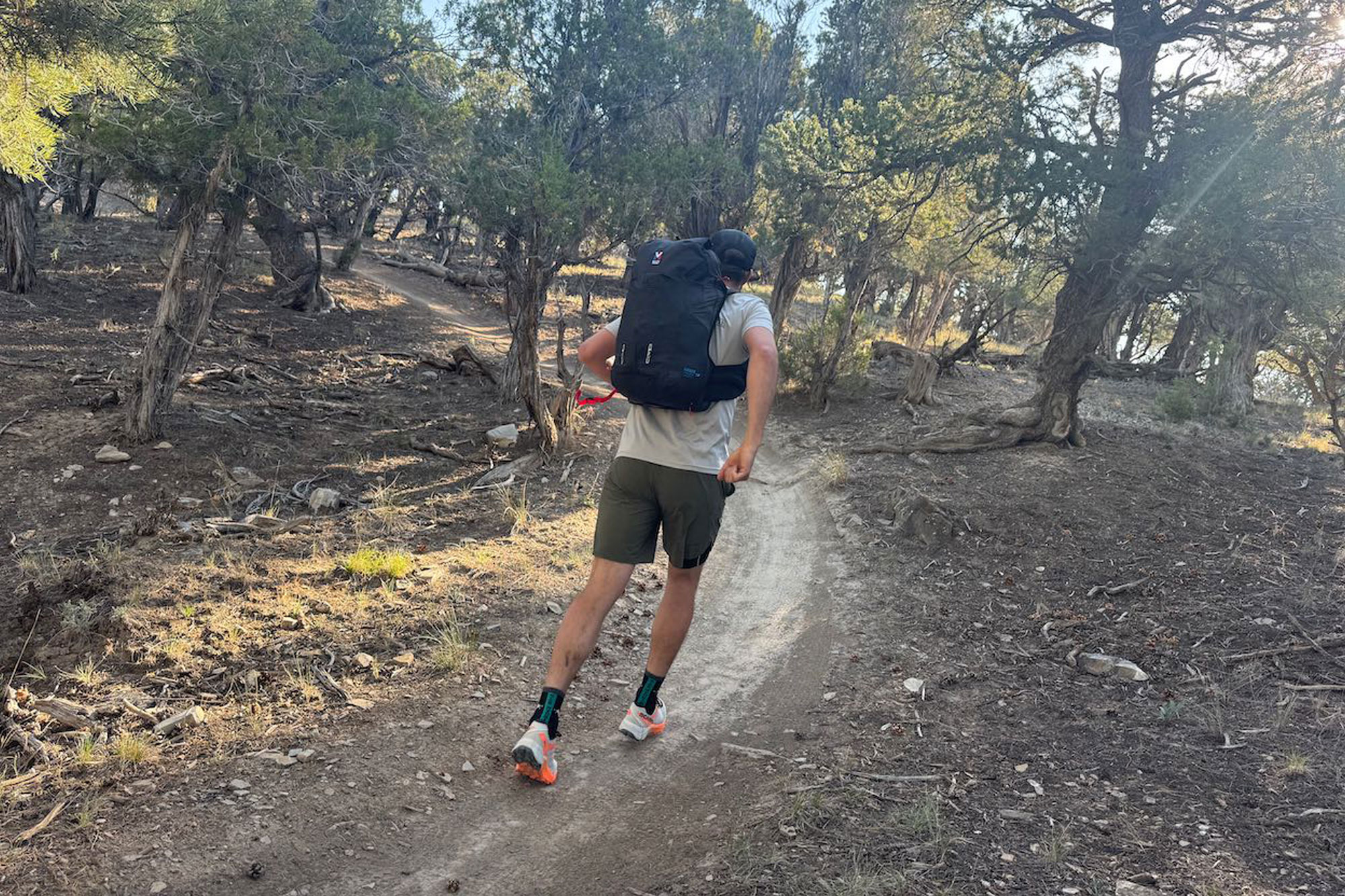 wearing Millet Trilogy Sky 25+ backpack while running