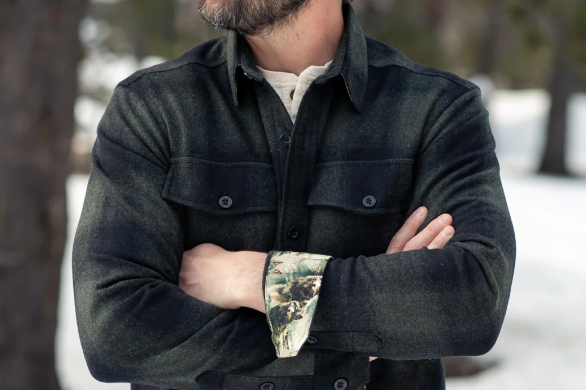 an outdoorsman wearing the pladra workhorse wool flannel shirt, highlighting the chest pockets