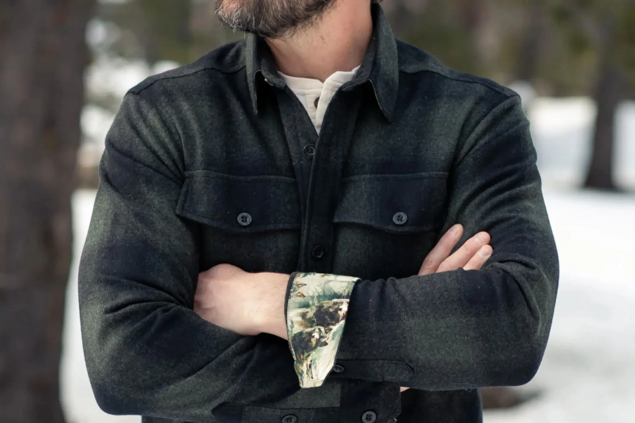 an outdoorsman wearing the pladra workhorse wool flannel shirt, highlighting the chest pockets