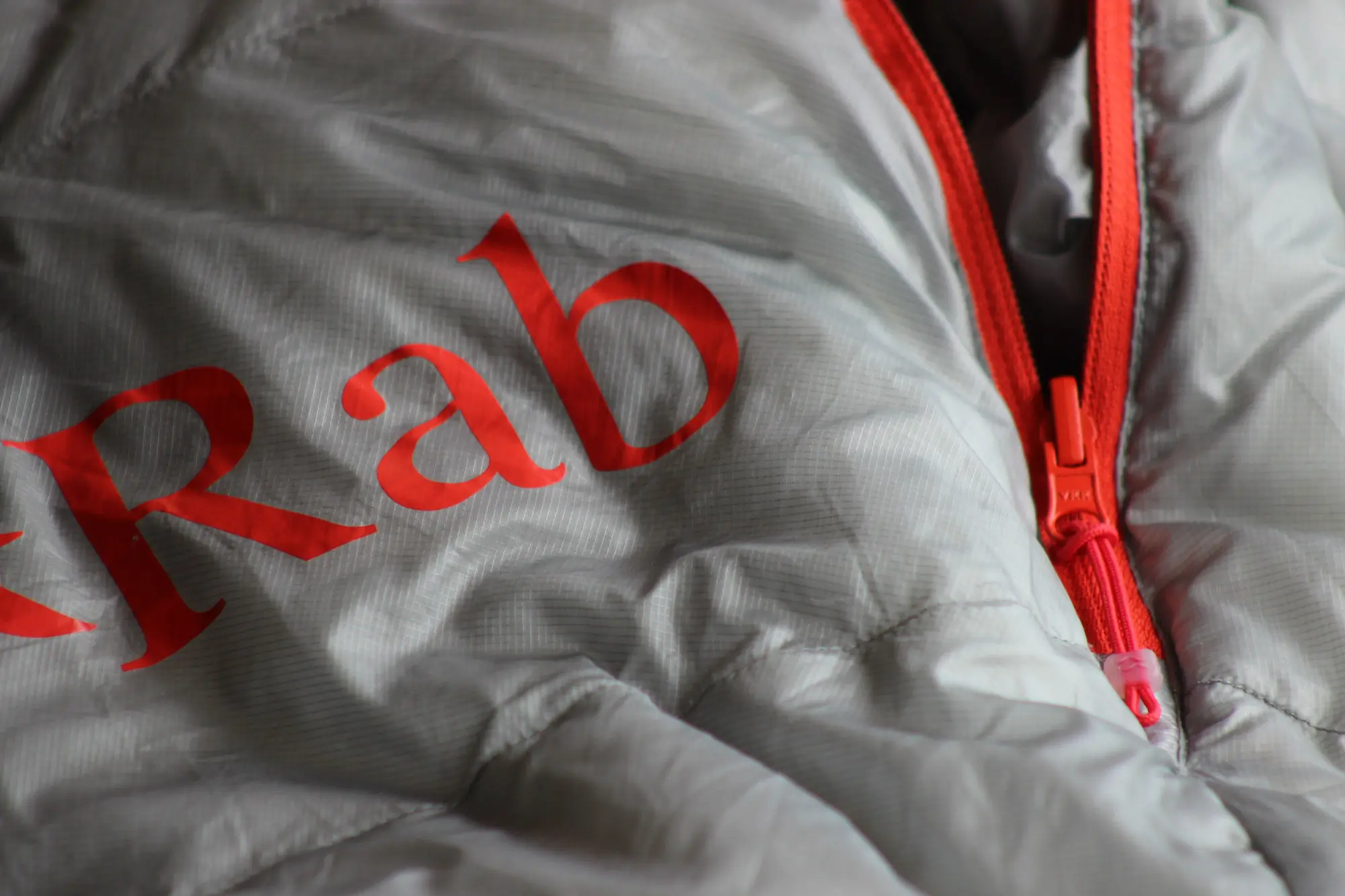 a tight shot of the shell fabric and zipper on the rab bag