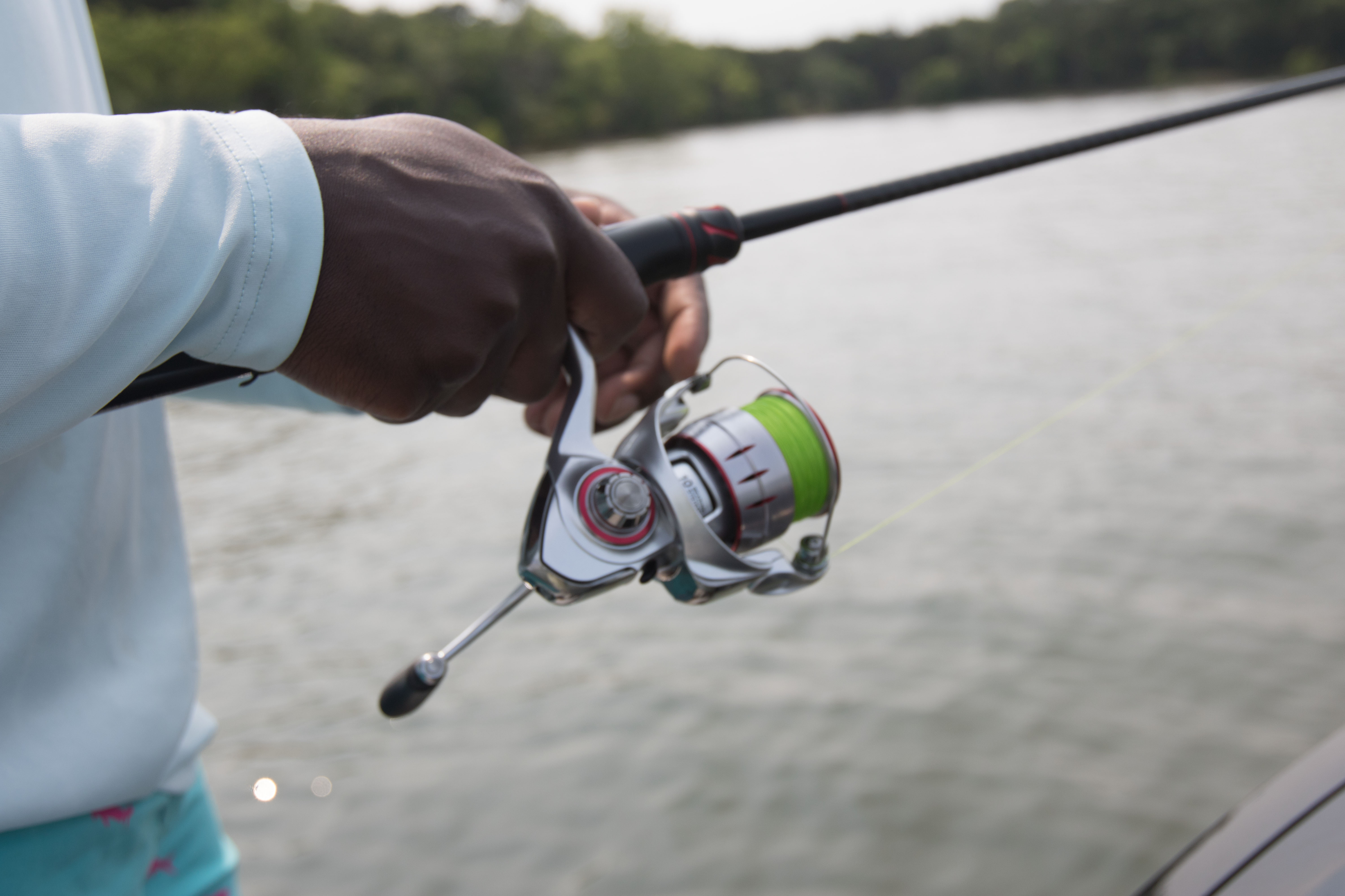 The Johnny Morris Platinum Signature spinning reel retrieving a lure