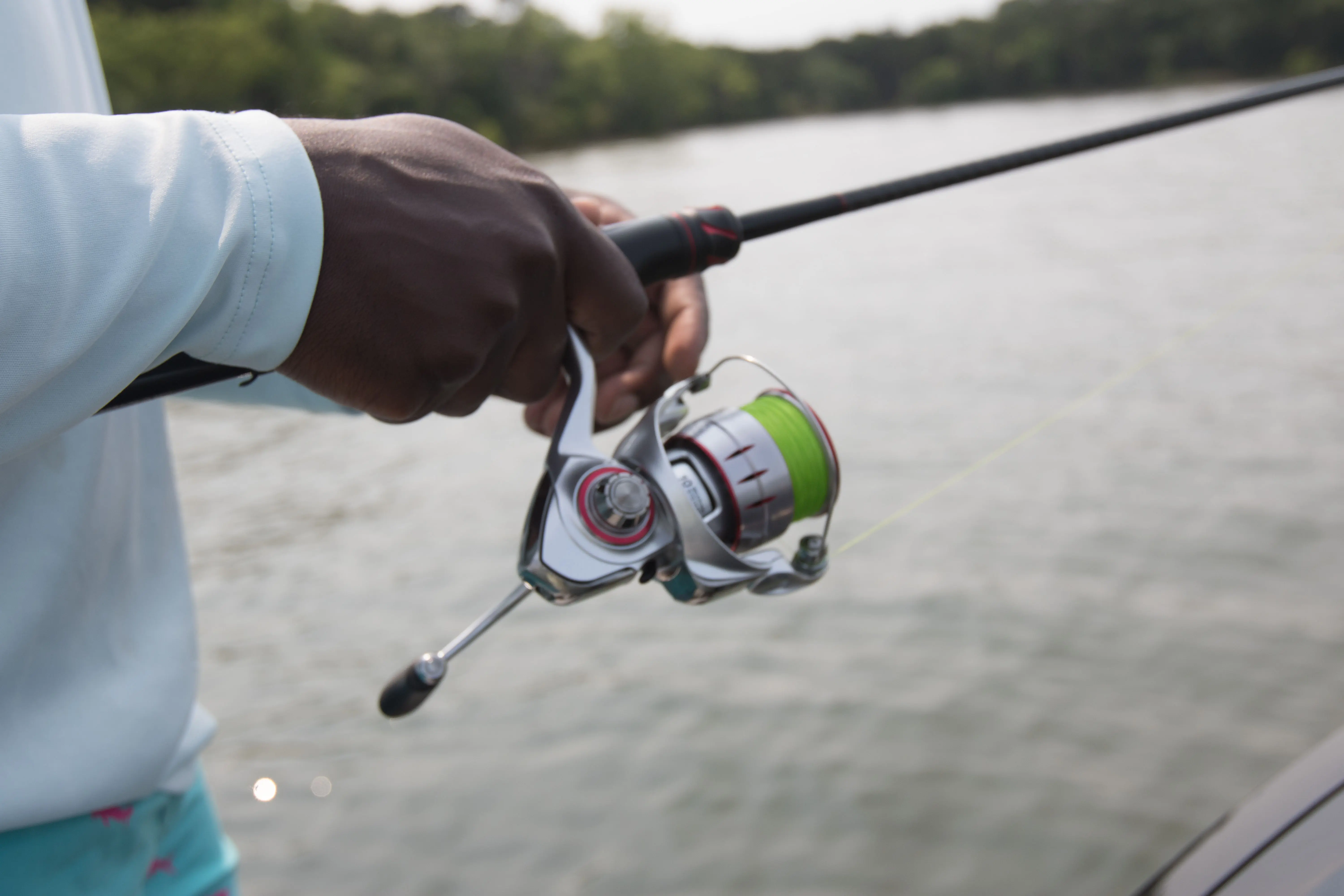 The Johnny Morris Platinum Signature spinning reel retrieving a lure
