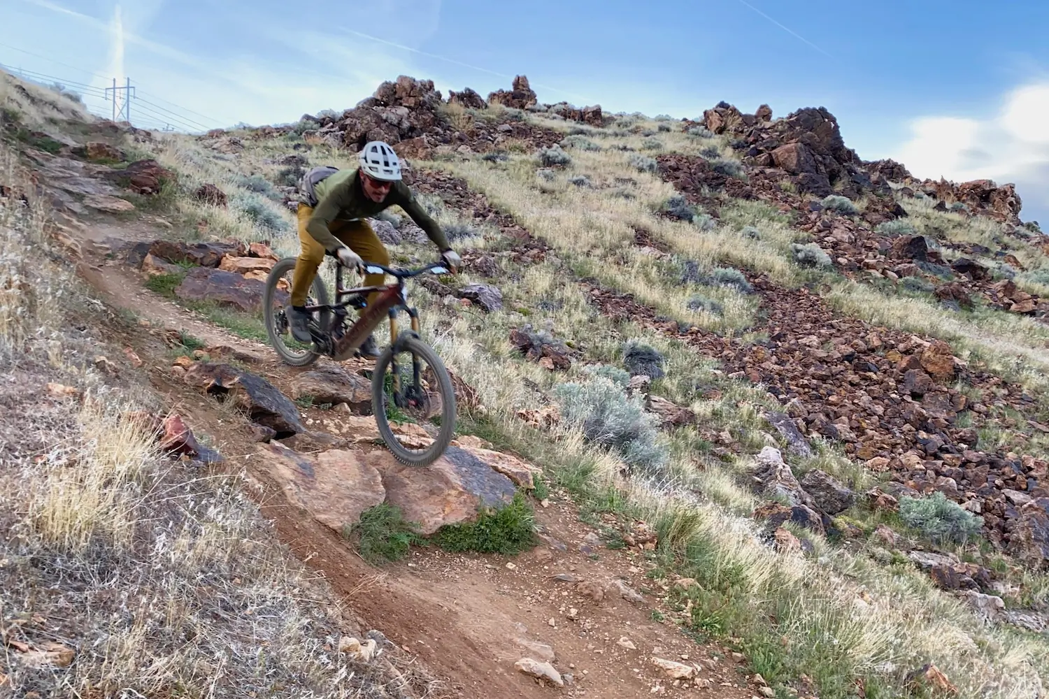 Riding the Turbo Levo down a steep and rocky trail