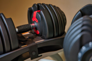 Dumbbells,Sitting,On,Rack.,Adjustable,Bowflex,Weights,On,Stand.
