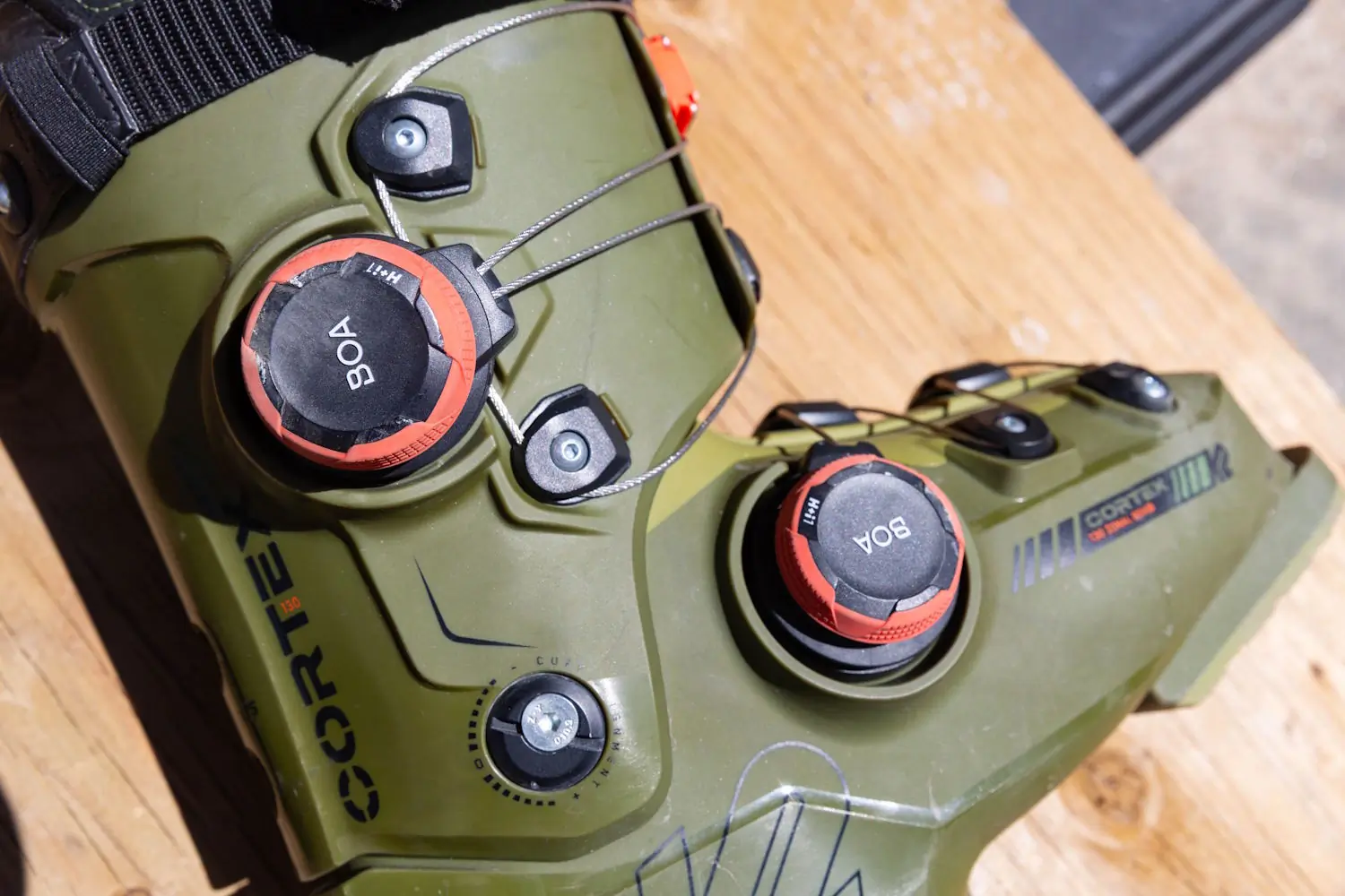 Close-up of the green K2 Cortex 130 ski boot shell showing the dual BOA H+i1 dials