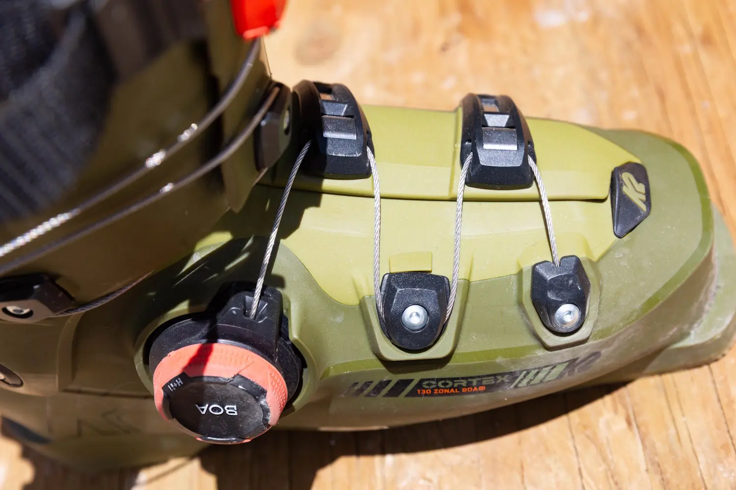 Close-up of the lower BOA dial and cable routing on the olive green K2 Cortex 130 Zonal BOA ski boot
