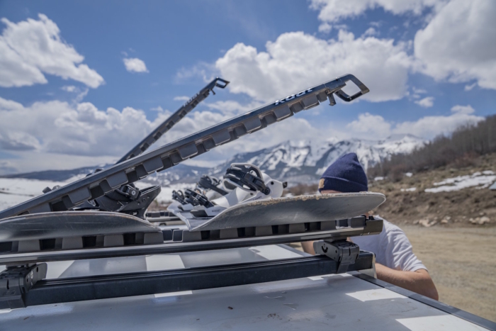 Skis mounted on a Kuat Grip 6 Ski/Snowboard Rack with the arms open
