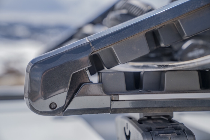 Close-up view of the Kuat Grip 6 Ski/Snowboard Rack showing the end section and rubber grips holding gear securely