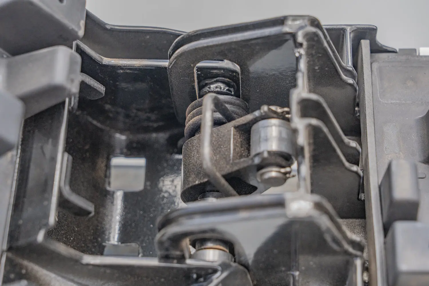 Close-up view of the internal hinge and spring mechanism of the Kuat Grip 6 Ski/Snowboard Rack, showing its construction and locking components