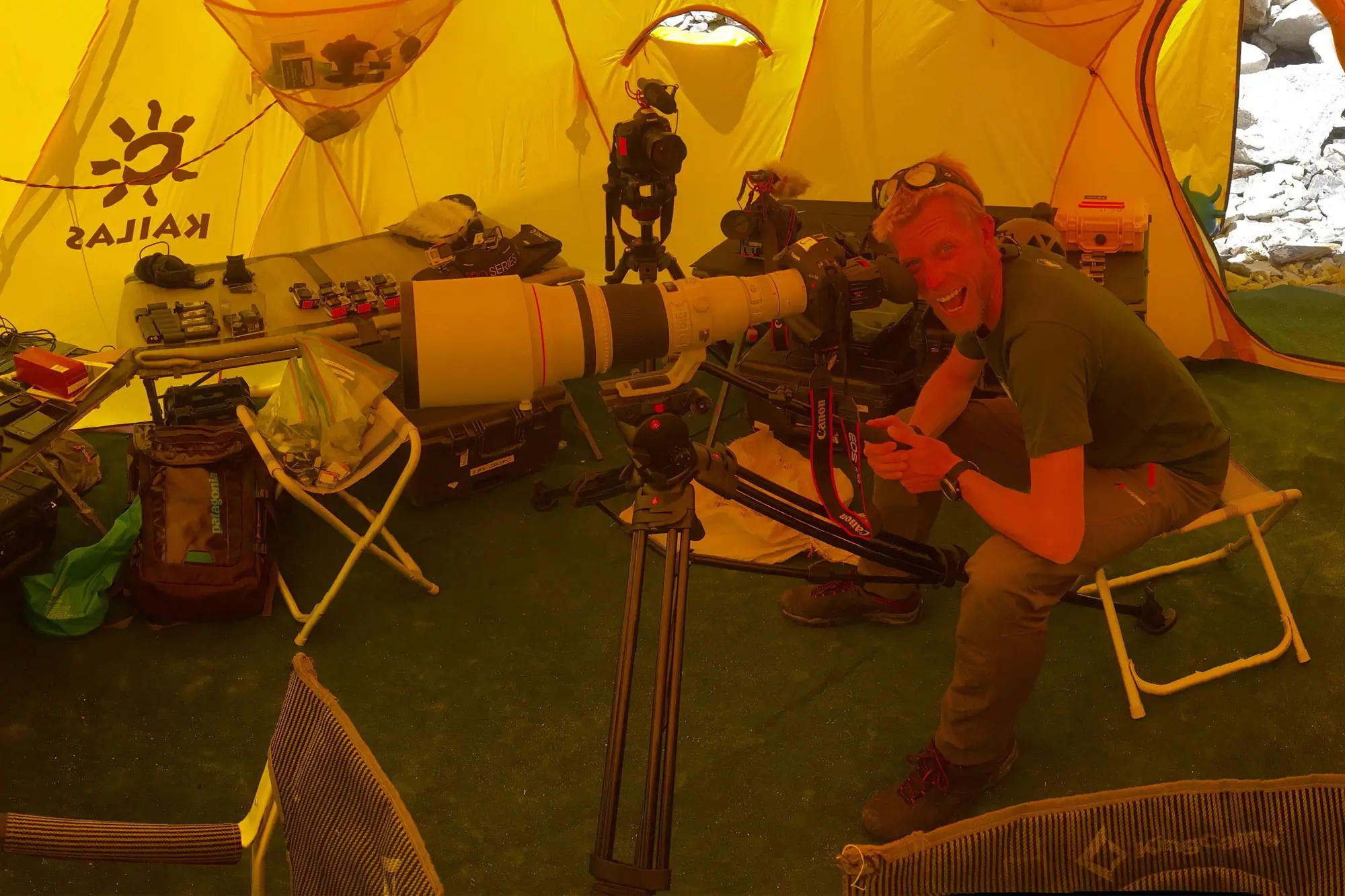 a man in a tent with photography equipment