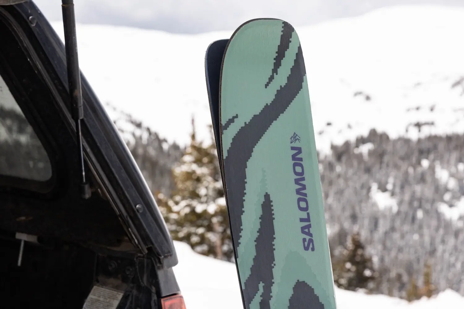 Salomon QST 94 skis in snowy mountain setting.
