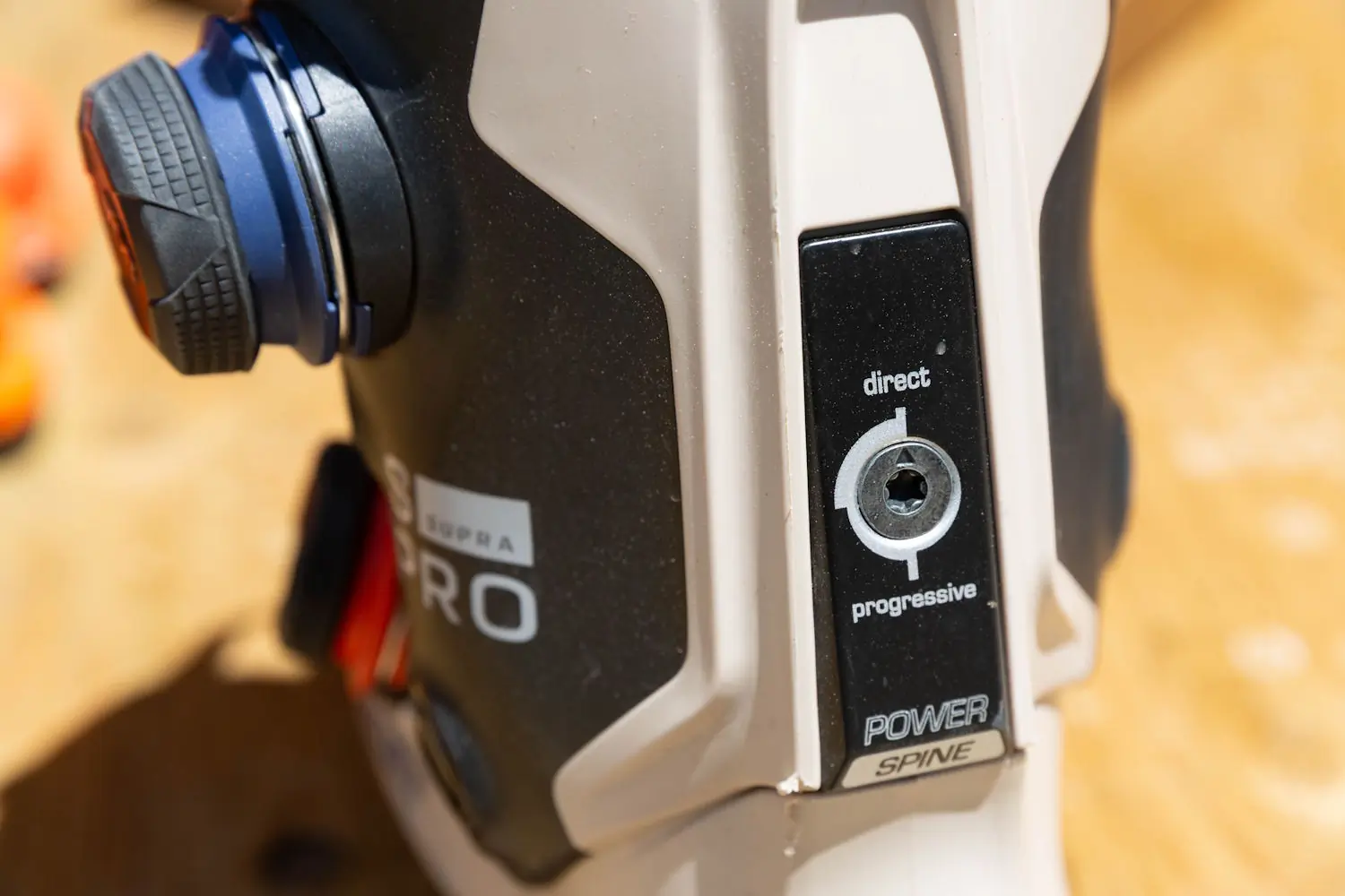 Close-up of the Power Spine adjustment dial on the Salomon S/Pro Supra 120 Ski Boots showing direct and progressive flex modes.