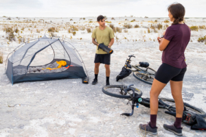 two people standing next to sea to summit bikepacking tent