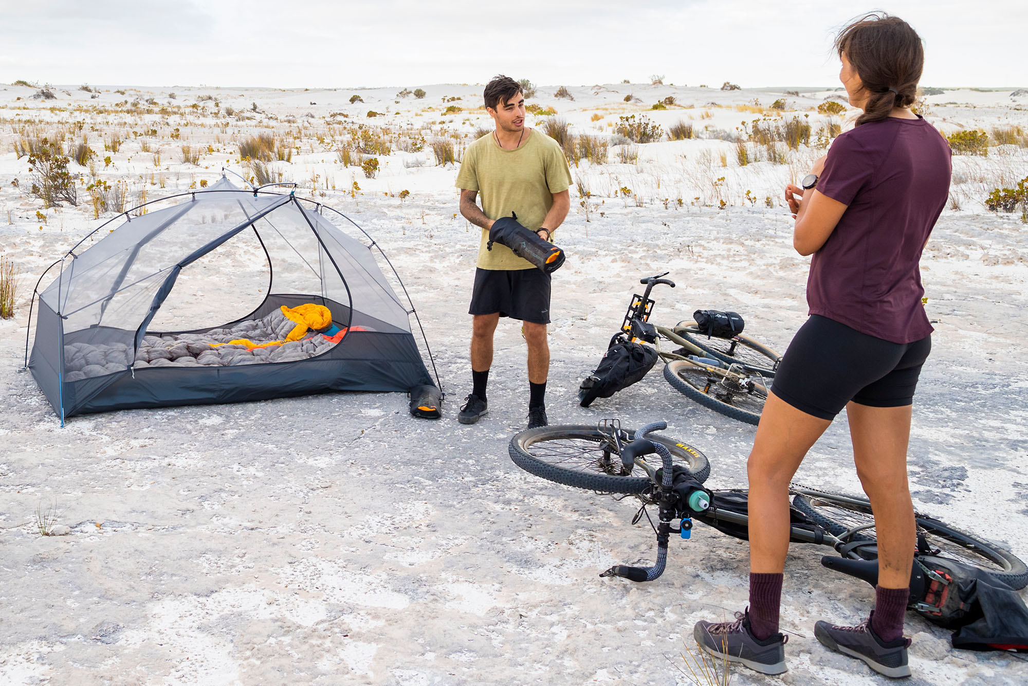 two people standing next to sea to summit bikepacking tent