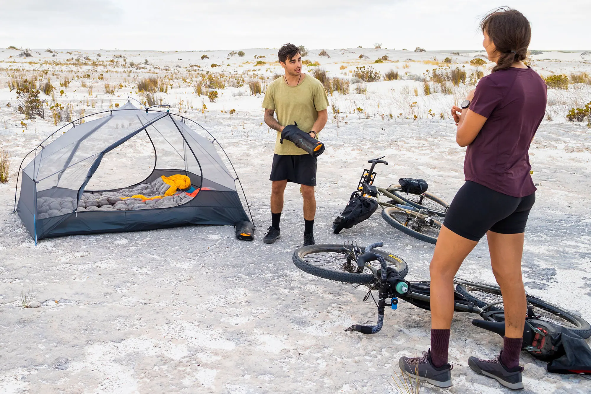 two people standing next to sea to summit bikepacking tent