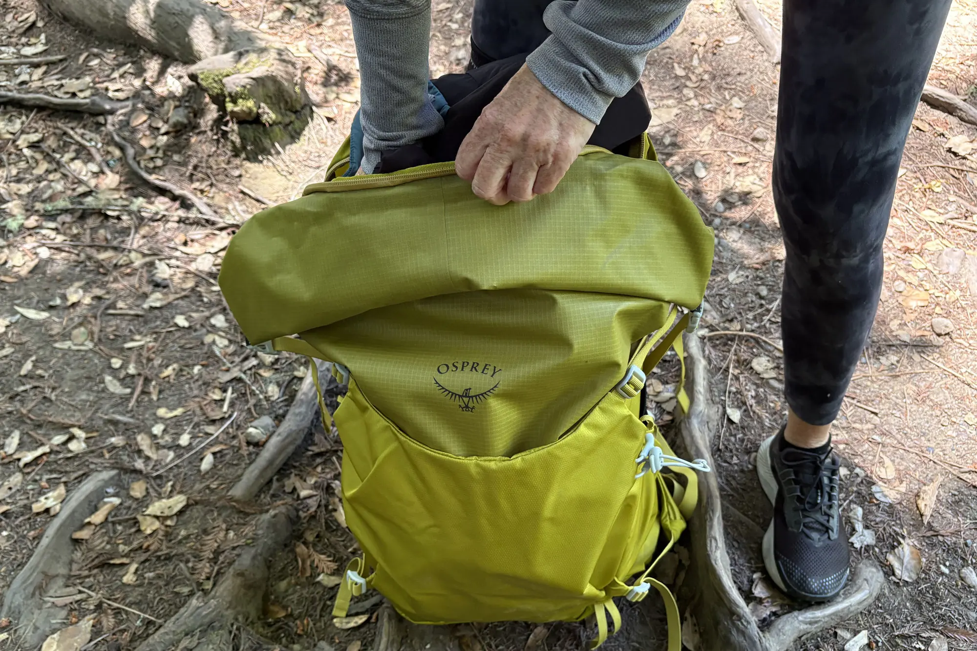 a yellow Osprey Downburst Daypack on the ground