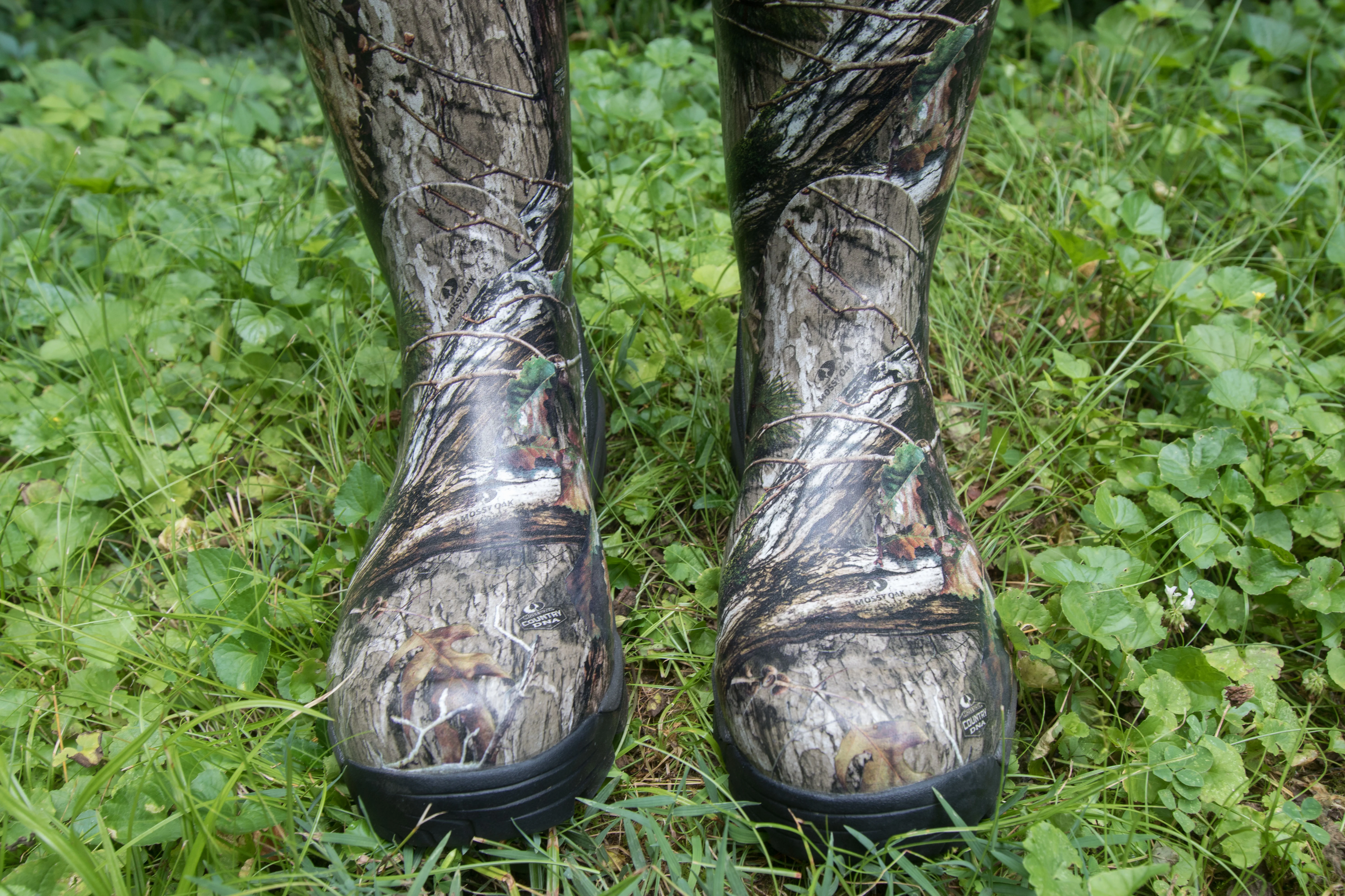 A pair of camouflage boots on vegetation
