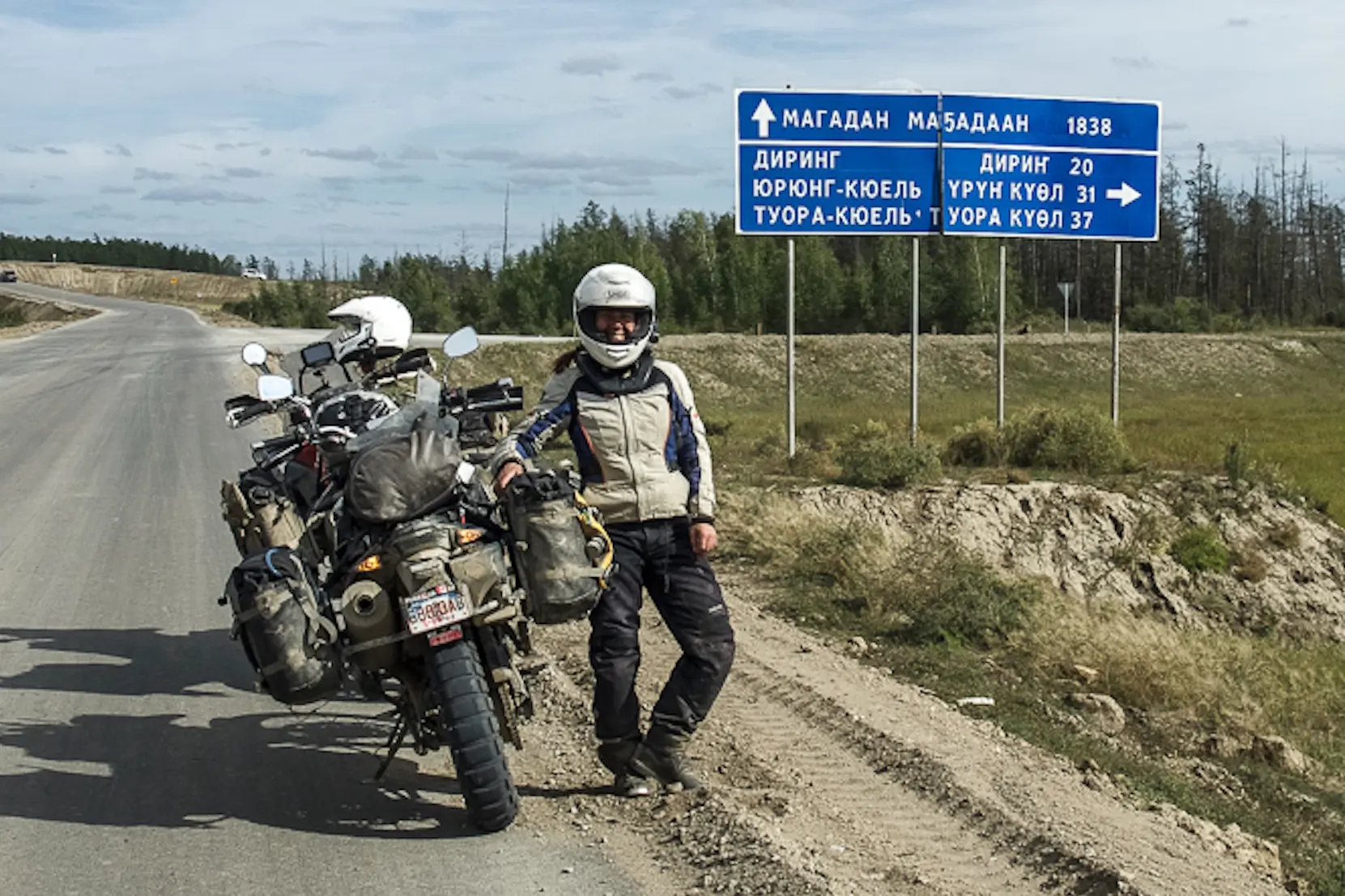 motorcyclist near road sign in russia
