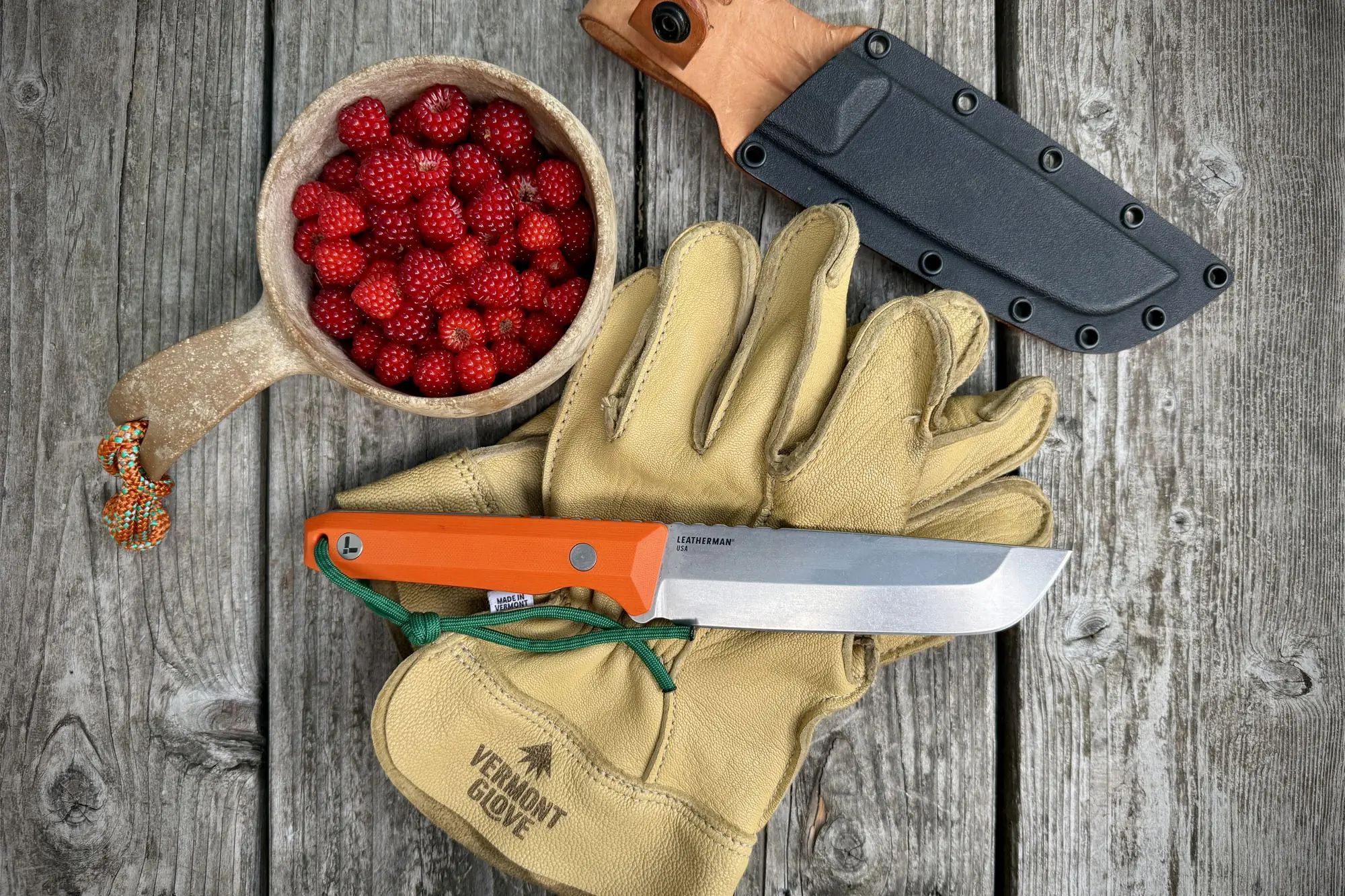 Leatherman Pioneer on gloves next to a bowl of strawberries