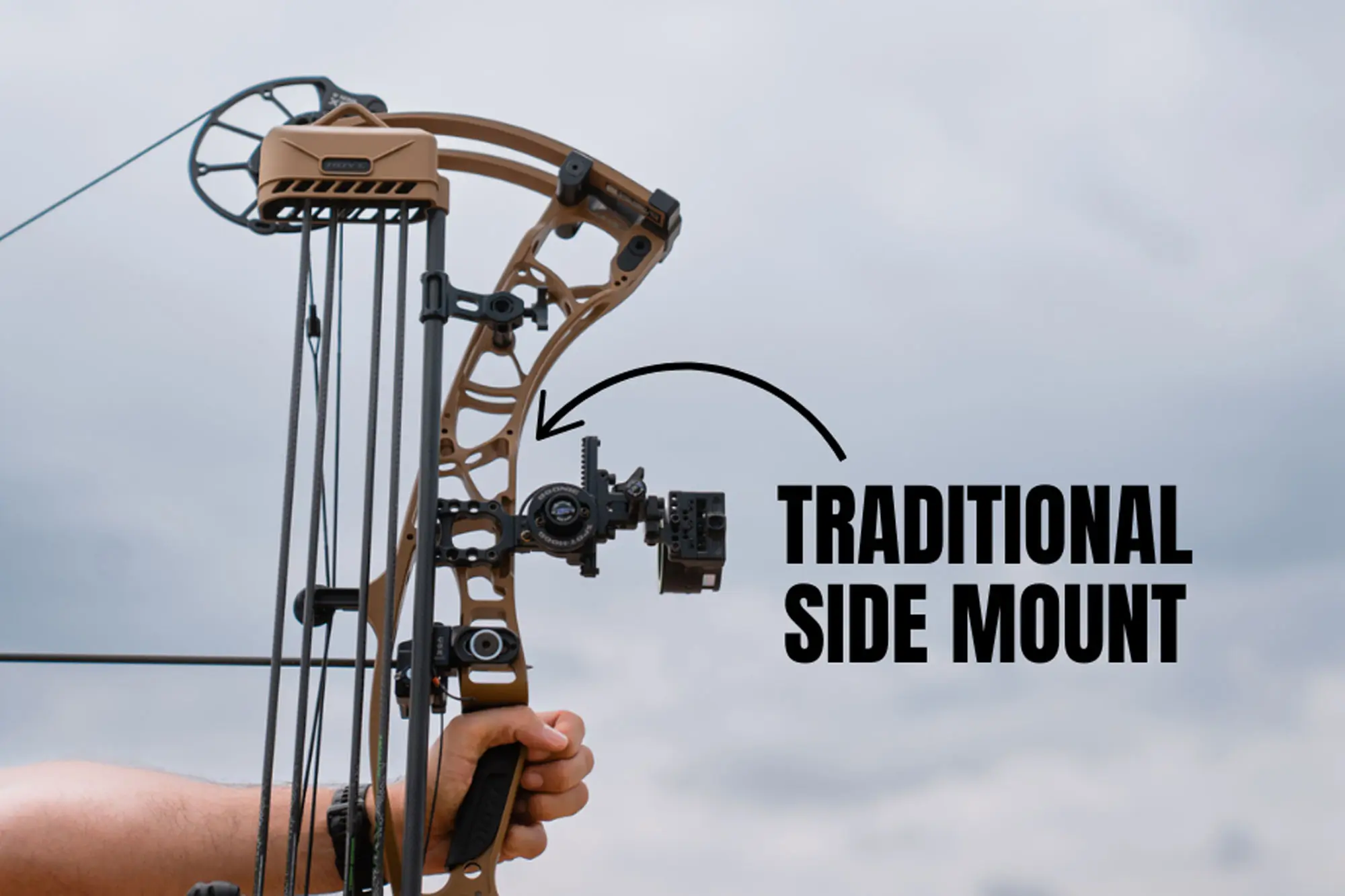 Man holding a bow showing side mount