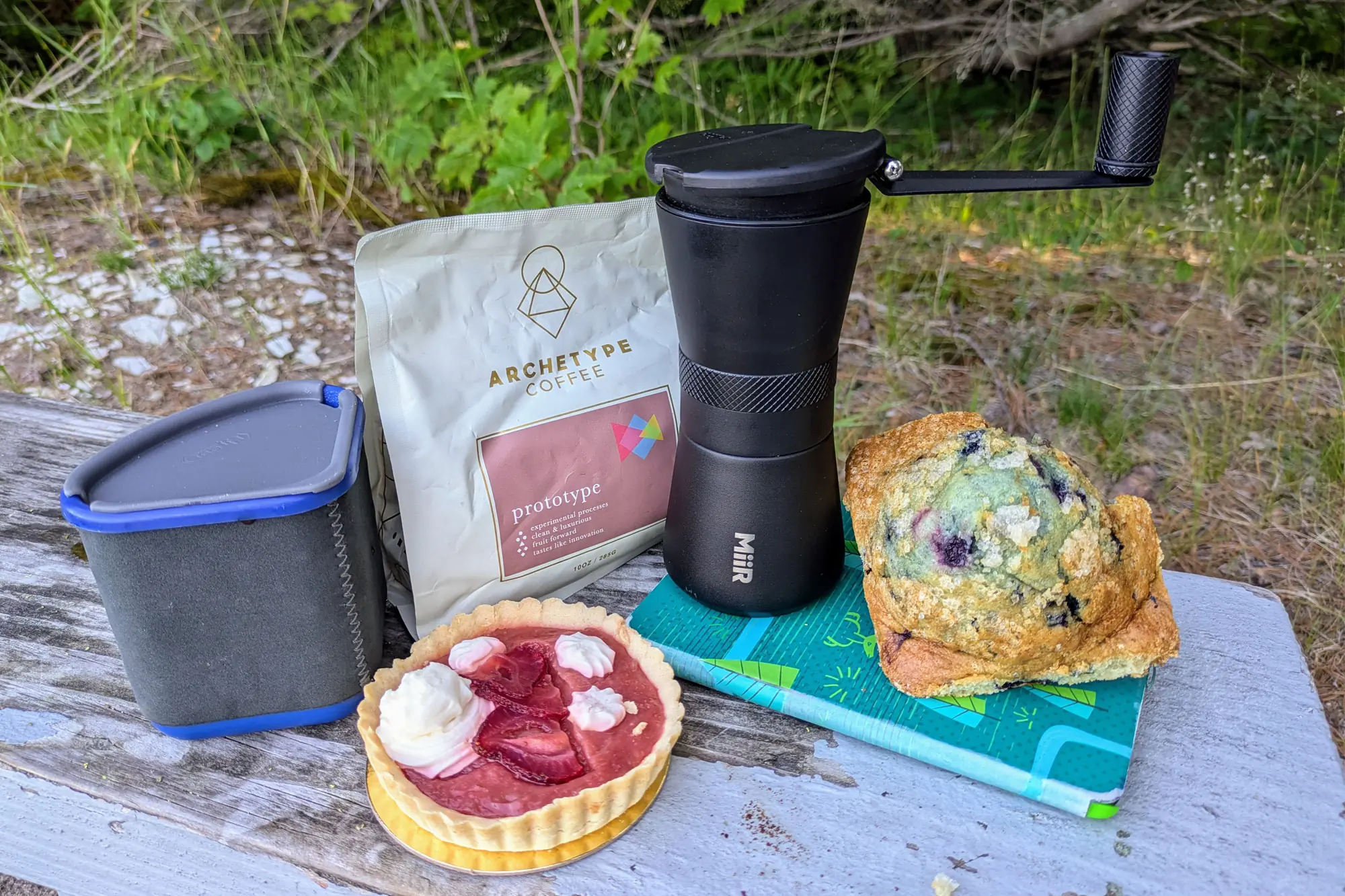 MiiR Grinder, Archetype coffee and some food on a wooden surface