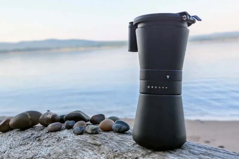 MiiR New Standard Hand Grinder by the lake on driftwood